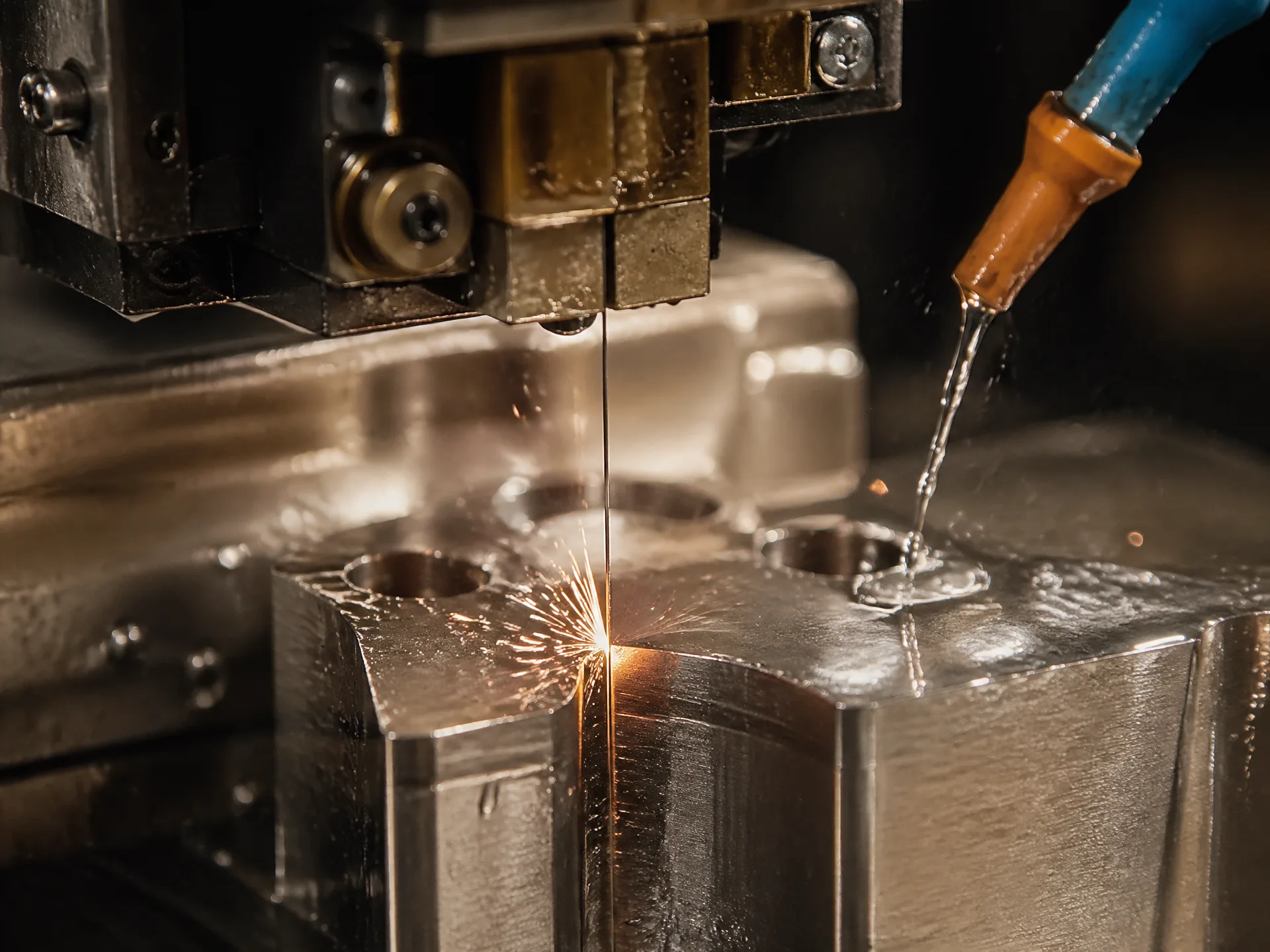 Wire EDM machining cutting detailed slots in a metal part
